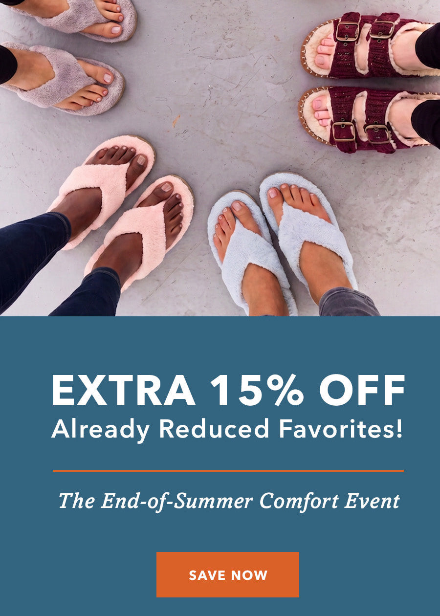 A promotional graphic showing multiple pairs of women's slide sandals arranged in a circle on a light gray floor, with a dark teal banner at the bottom reading 'EXTRA 15% OFF Already Reduced Favorites!' and 'The End-of-Summer Comfort Event' with a 'SAVE NOW' button.