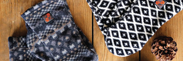 Flatlay of Versafit socks on wood background with pinecones