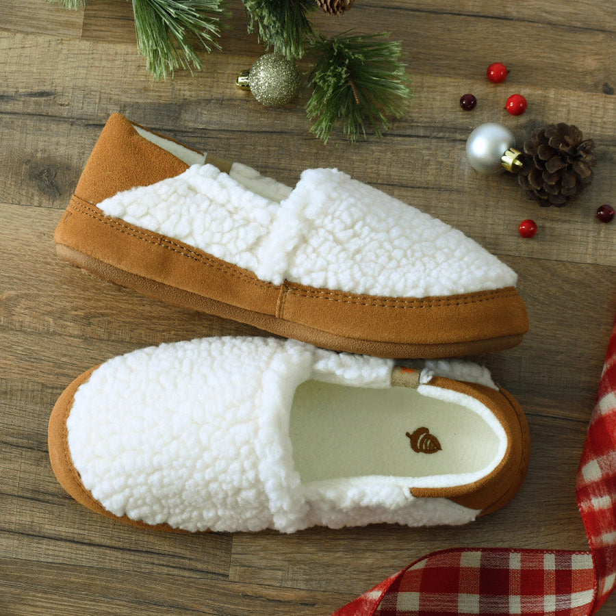 "Holiday Gift Guide - Find the perfect gift for everyone on your list" on a red background with a pinecone illustration and a picture of the Collapsible Heel Moc flatlay with holiday ribbon, cranberries and evergreen